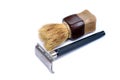 The old safety razor and small brush on a white background. Personal care products for shaving.