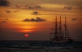 Old sailing ship in the sea at sunset