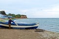 An old sailor in maintenance of his boat.