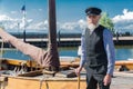 Old sailor standing for traditional fishing boat in harbor Urk Royalty Free Stock Photo