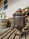 Old samovar on the background of firewood