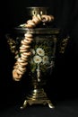 A closeup shot of a samovar in a beautiful interior setting on a black background Royalty Free Stock Photo