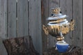 Old samovar on stump and cup Royalty Free Stock Photo