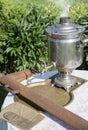 An old samovar was to boil on a table in the garden Royalty Free Stock Photo