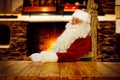 Old Santa Claus sitting in old throne chair in home interior and wooden table top with free space for your decoration. Royalty Free Stock Photo