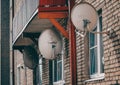 Old satellite dishes hanging on the wall Royalty Free Stock Photo