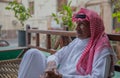 An old Saudi man sits on a balcony in the old city of Jeddah, Saudi Arabia 2020