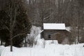 Old sawn log cabin in the snow in winter landscape Royalty Free Stock Photo