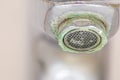 Old scaled faucet as calcified chrome handle in the bathroom needs maintenance and decalcification with cleaning agents stop leak Royalty Free Stock Photo