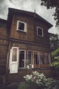 Old scary house against dark cloudy moody sky