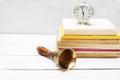 Old school bell and old clock on a pile of books. Education concept Royalty Free Stock Photo