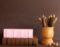 Old school books and wooden pencils