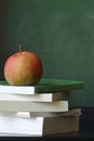 Old school eductation with a chalckboard a books with a red apple on top of the books Royalty Free Stock Photo