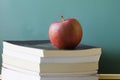 Old school eductation with a chalckboard a books with a red apple on top of the books Royalty Free Stock Photo