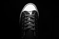 Old school fashion sport shoe. Close-up of vintage sneaker shoe. Black and white photo.