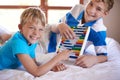 Old-school math. Portrait of two young siblings playing with an abacus. Royalty Free Stock Photo