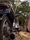 an old school motorbike that is still suitable for use seen from the back