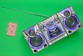 Old school retro tape recorder and audio cassette on a green background. Royalty Free Stock Photo