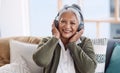 Old-school tunes are my thing. Portrait of a senior woman wearing headphones while listening to music at home. Royalty Free Stock Photo