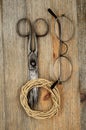 Old scissors, glasses and hank of packthread over wooden texture