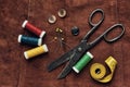 Old scissors and sewing objects on a natural suede background