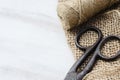 Old scissors, skein jute twine and burlap. Royalty Free Stock Photo