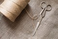 Old scissors and skein jute twine on a burlap, rustic Royalty Free Stock Photo