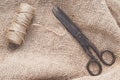 Old scissors and skein jute twine on a burlap. Royalty Free Stock Photo