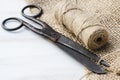 Old scissors, skein jute twine and burlap. Royalty Free Stock Photo