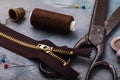 Old scissors, zipper for clothes and other tools for sewing and minor repairs