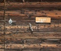 Old scratched letter mailbox on rustic wooden front door