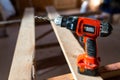 Old, scratched, used Black and Decker cordless  screwdriver in a small woodworking shop. Royalty Free Stock Photo