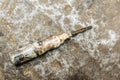 Old screwdriver on rumpled shabby metal, close-up abstract background