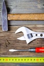 old screwdriver, screws, monkey wrench, vintage hammer and tape-measure Royalty Free Stock Photo