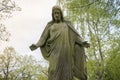 Old sculpture of jesus in a park