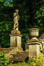 Old sculpture on the pedestal, beautifully preserved old artistic figure, decorative elements on the outside, vintage Royalty Free Stock Photo