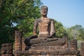 Old sculpture of a seated Buddha at the ruins of the Buddhist temple. Kamphaeng Phet, Thailand