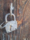 Old security lock on wooden door Royalty Free Stock Photo