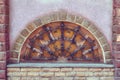 The old semicircular window with bars. Wooden window made in half circle. and stoned Royalty Free Stock Photo