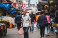 Old senior asian man buying groceries on street food market in Hong Kong