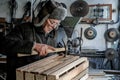 Old senior carpenter in grey warm clothes in eyeglasses