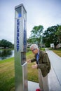 Old senior man calling for help at a public safety beacon emergency