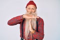 Old senior man with grey hair and long beard wearing hipster look with wool cap doing time out gesture with hands, frustrated and Royalty Free Stock Photo