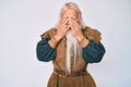 Old senior man with grey hair and long beard wearing viking traditional costume rubbing eyes for fatigue and headache, sleepy and Royalty Free Stock Photo