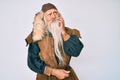 Old senior man with grey hair and long beard wearing viking traditional costume thinking concentrated about doubt with finger on Royalty Free Stock Photo