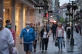 Old senior man wearing a respiratory face mask walking in a crowd in the street of Belgrade with a groceries bag Royalty Free Stock Photo
