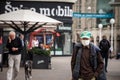 Old senior man wearing a respiratory face mask walking in a street of Zagreb, Croatia