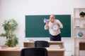 Old male teacher in time management concept Royalty Free Stock Photo