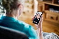 Old senior woman having a phone video call with young lady. Family communication. Mobile technology. Grandma using smartphone. Royalty Free Stock Photo