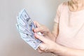 An old senior woman holding dollar cash money in hands Royalty Free Stock Photo